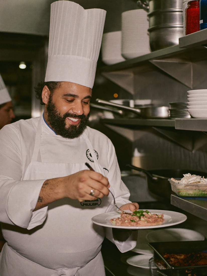 Cook plating food in a kitchen